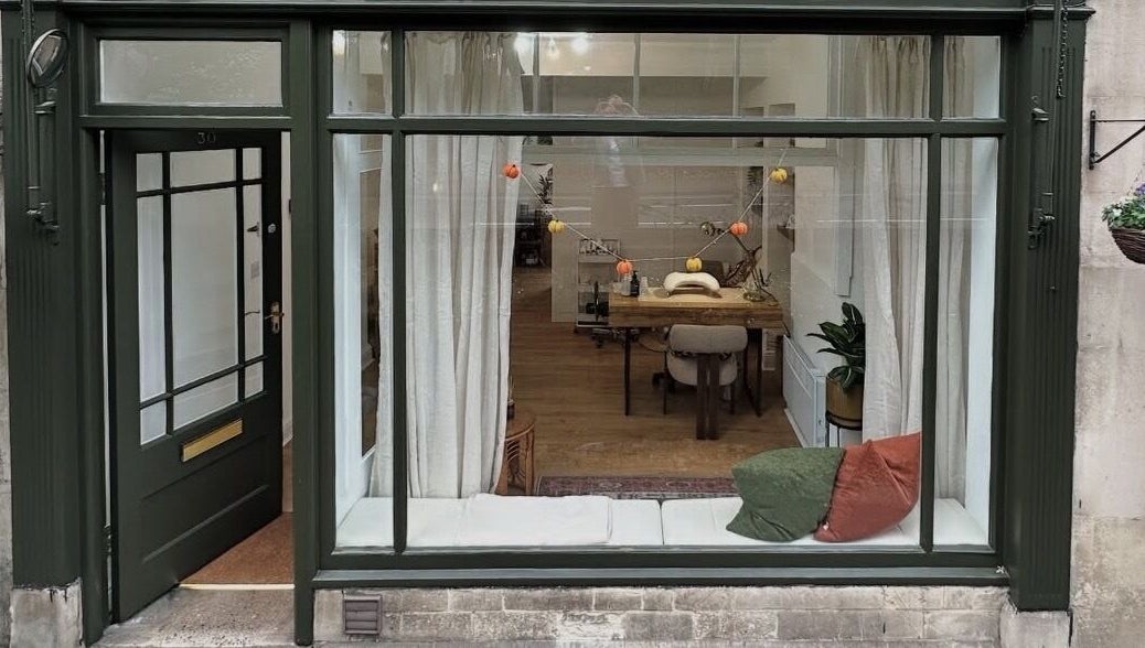 Chic storefront of Skin by Fran, Bath, England, GB, showcasing cozy interior and large window display.