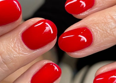 Stunning red manicure at Ninety Eight Nails, Glasgow, Scotland, GB, showcases glossy nail art.