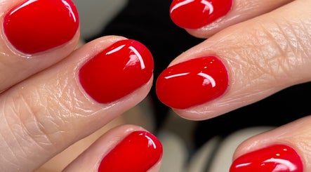 Stunning red manicure at Ninety Eight Nails, Glasgow, Scotland, GB, showcases glossy nail art.