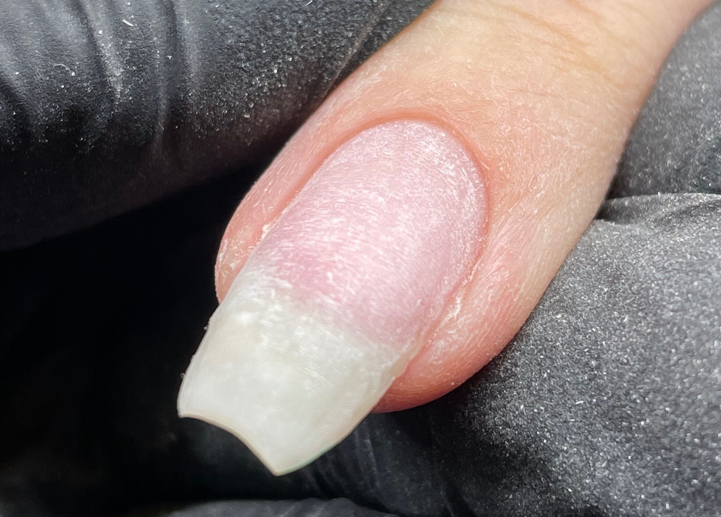 Close-up of a polished nail at Ninety Eight Nails, Glasgow, Scotland, GB.