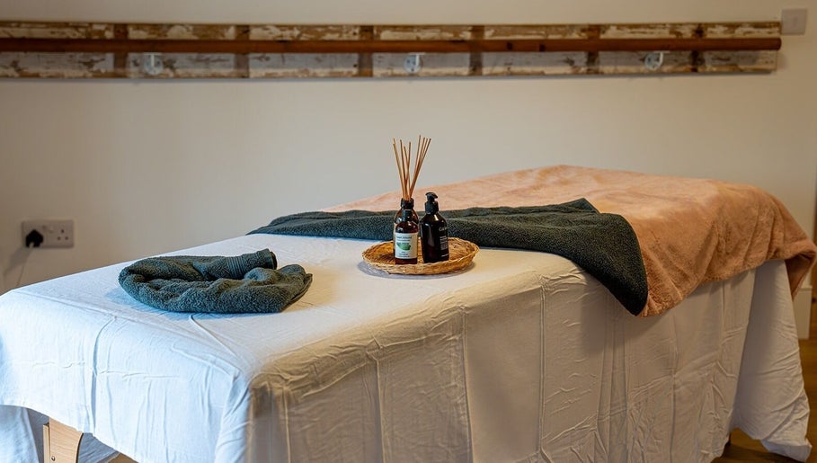 Massage table with oils at Anna Booth Massage & Yoga, Nailsworth, England, GB, providing a relaxing ambiance.
