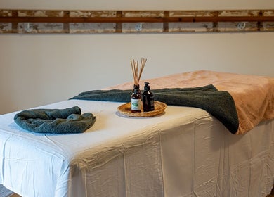 Massage table with oils at Anna Booth Massage & Yoga, Nailsworth, England, GB, providing a relaxing ambiance.