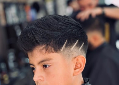 Peinado moderno en Barbería Copacabana®, Cuenca, Azuay, EC con detalle de líneas en el lateral.