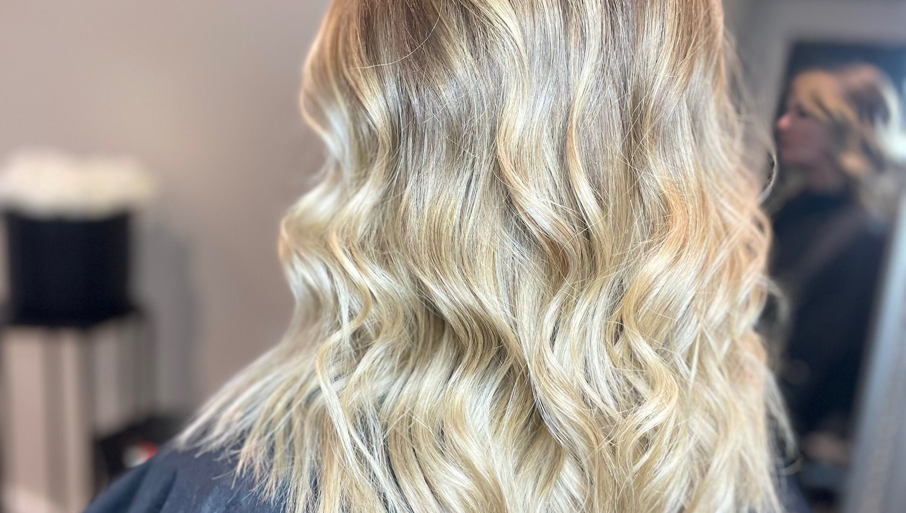Close-up of wavy blonde hairstyle at Meraki Hairdressing, Runcorn, England, GB.