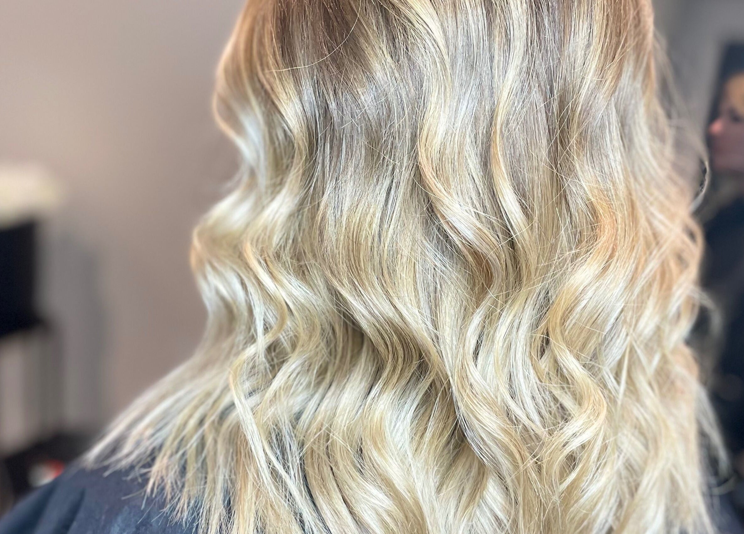 Close-up of wavy blonde hairstyle at Meraki Hairdressing, Runcorn, England, GB.