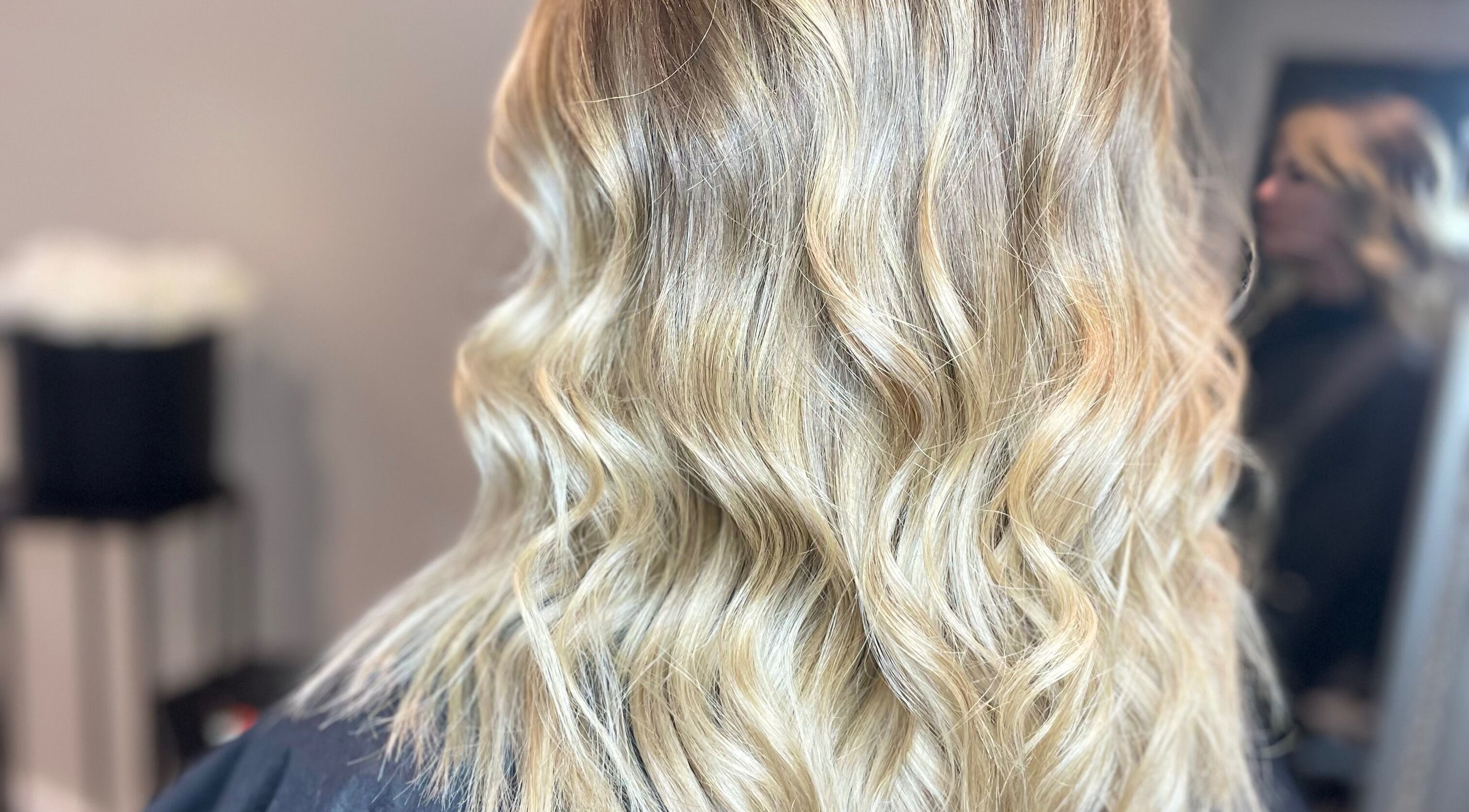 Close-up of wavy blonde hairstyle at Meraki Hairdressing, Runcorn, England, GB.
