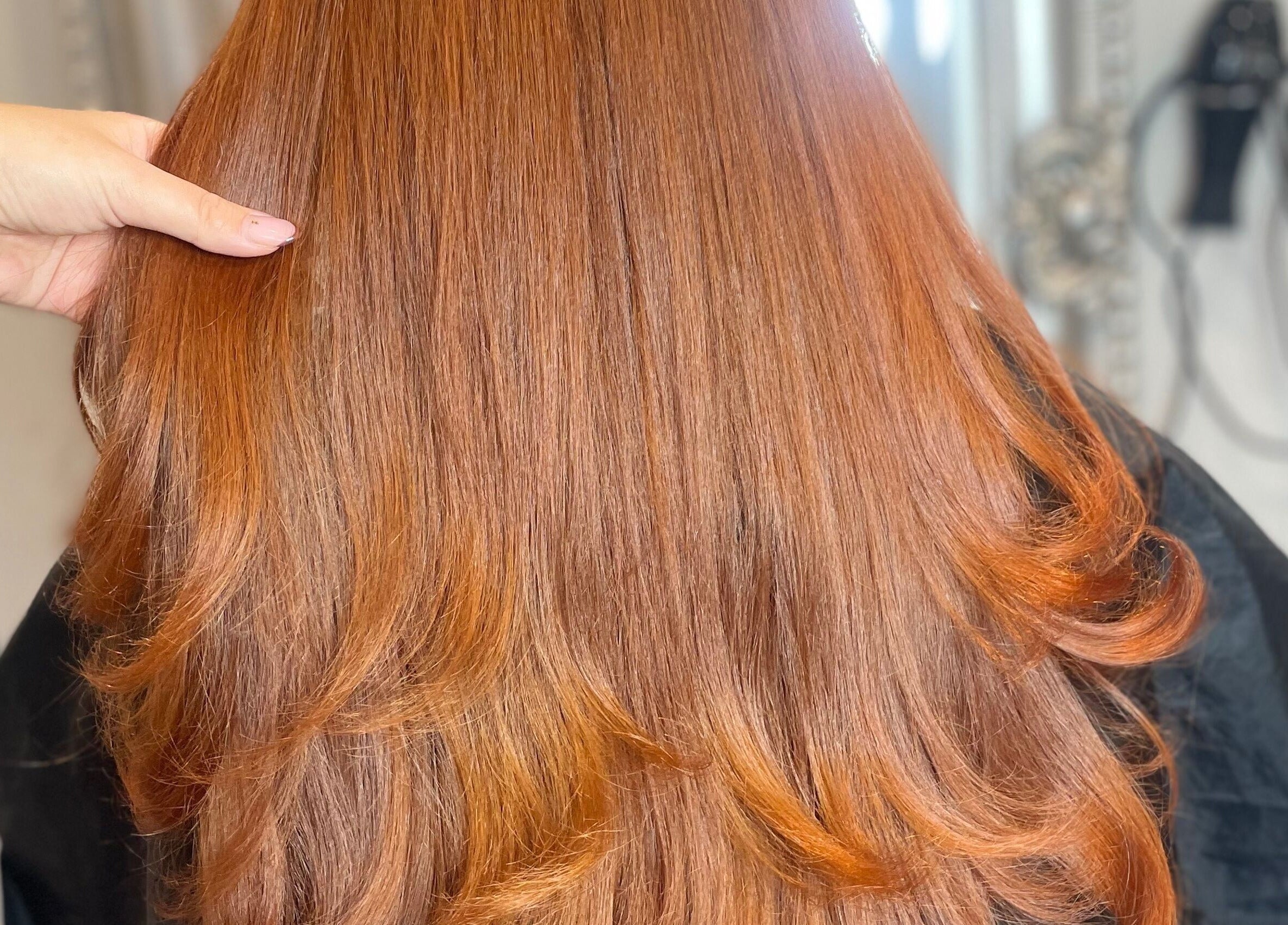 Beautiful, shiny red hair styled at Meraki Hairdressing, Runcorn, England, GB, showcasing expert hairstyling.