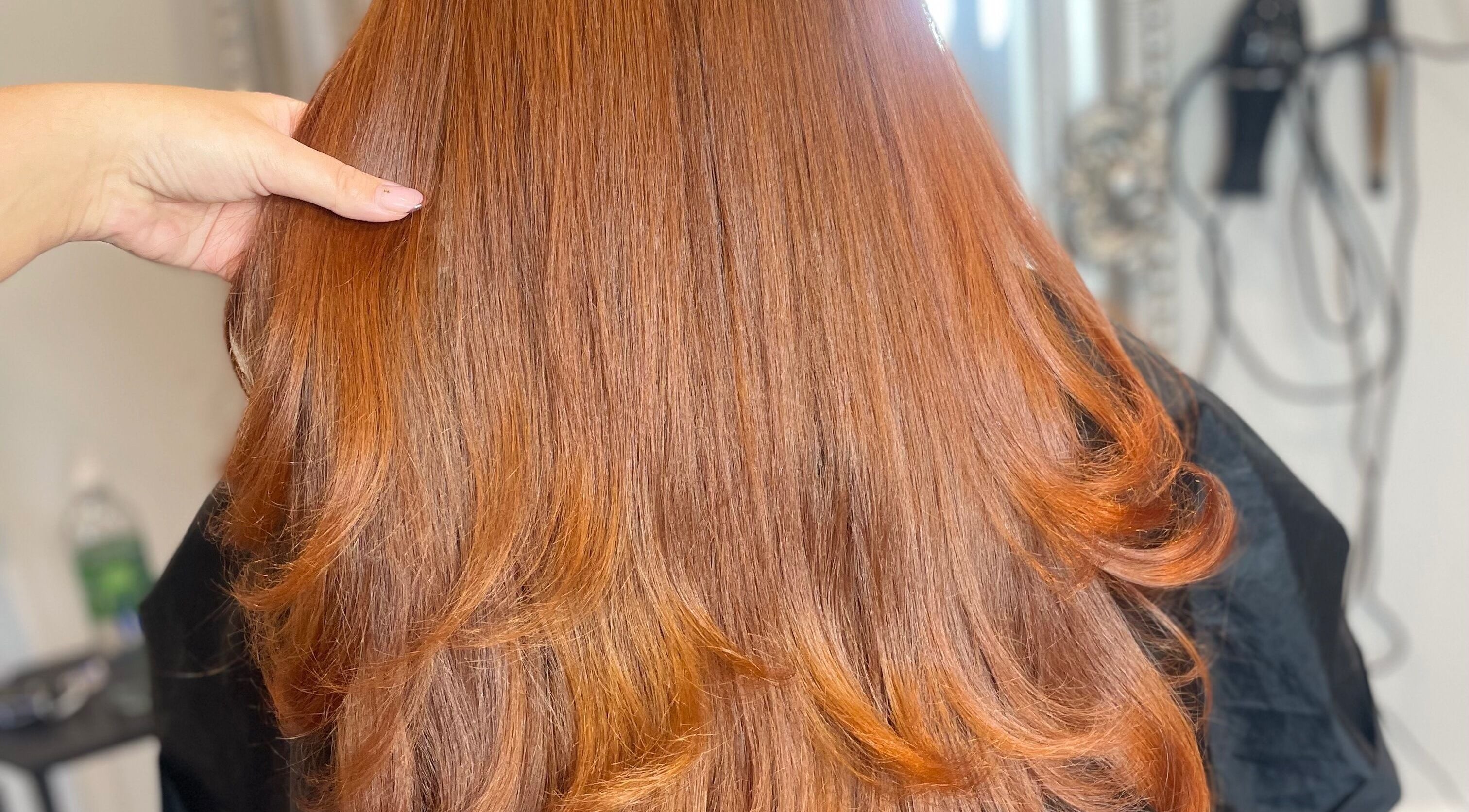 Beautiful, shiny red hair styled at Meraki Hairdressing, Runcorn, England, GB, showcasing expert hairstyling.