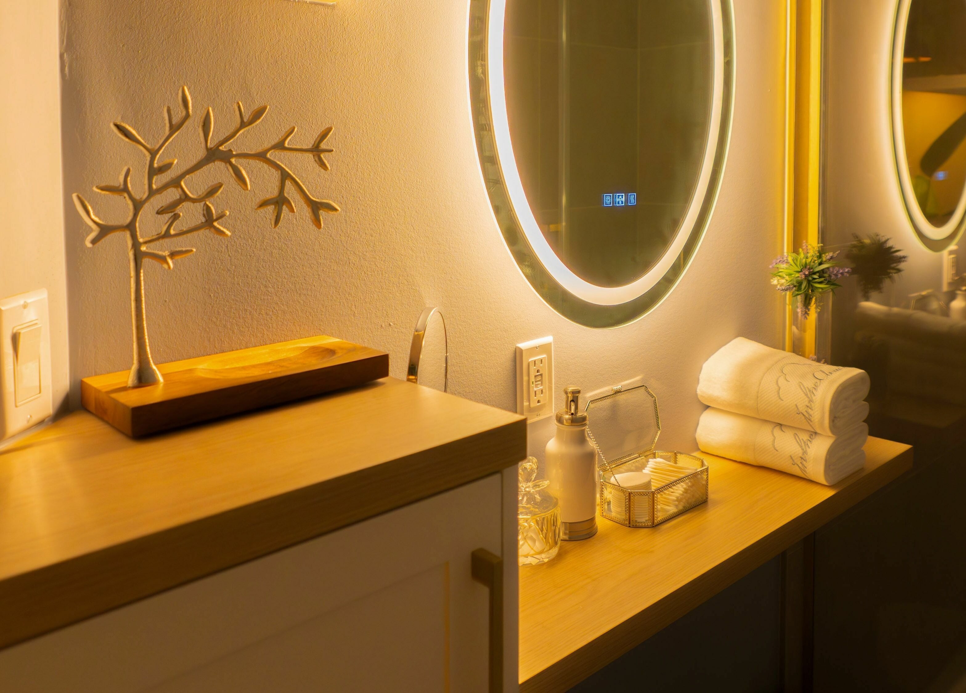 Elegant vanity at In The Cloud Spa, Toronto, Ontario, CA, with illuminated mirror and decor.
