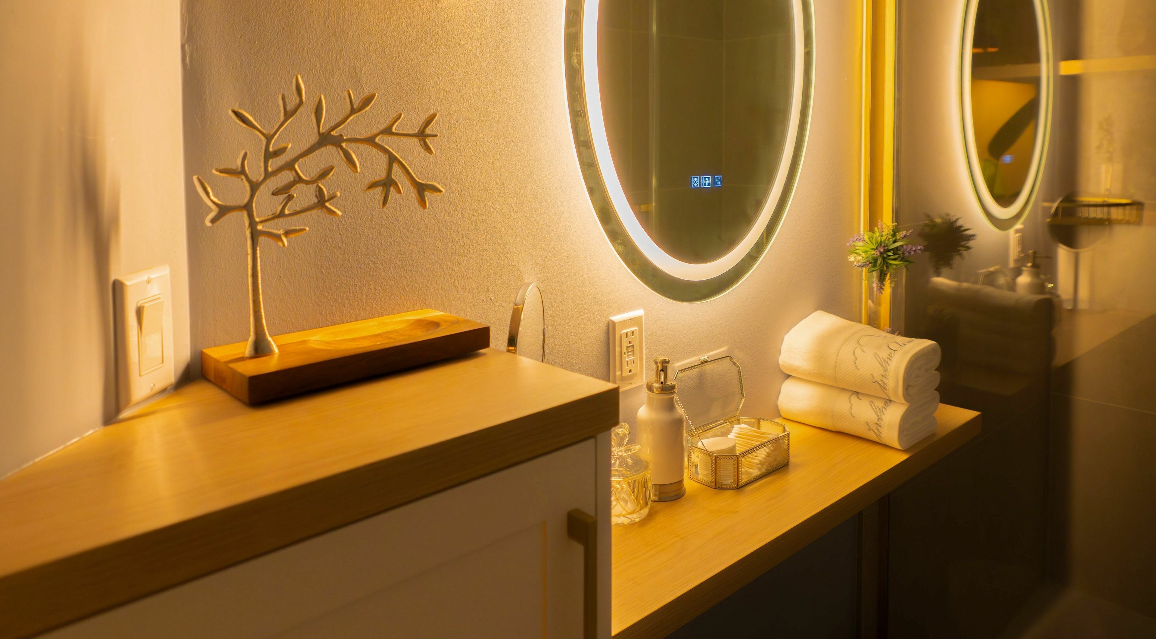 Elegant vanity at In The Cloud Spa, Toronto, Ontario, CA, with illuminated mirror and decor.
