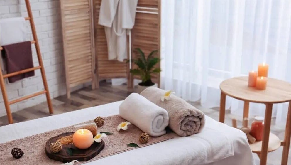 Relaxing spa setup with candles and towels at Soft Life Spa, Nassau, New Providence, BS.
