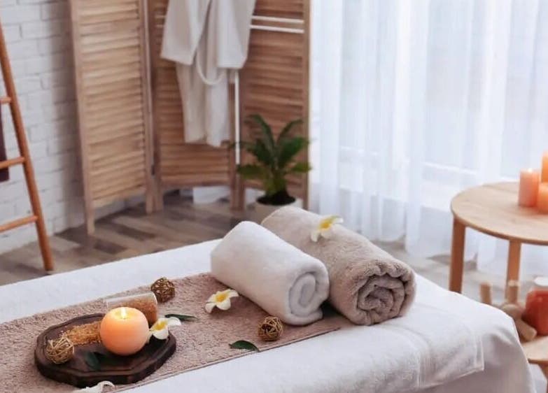 Relaxing spa setup with candles and towels at Soft Life Spa, Nassau, New Providence, BS.