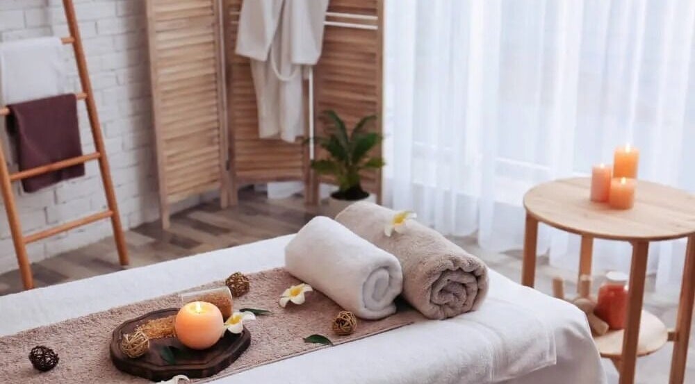 Relaxing spa setup with candles and towels at Soft Life Spa, Nassau, New Providence, BS.