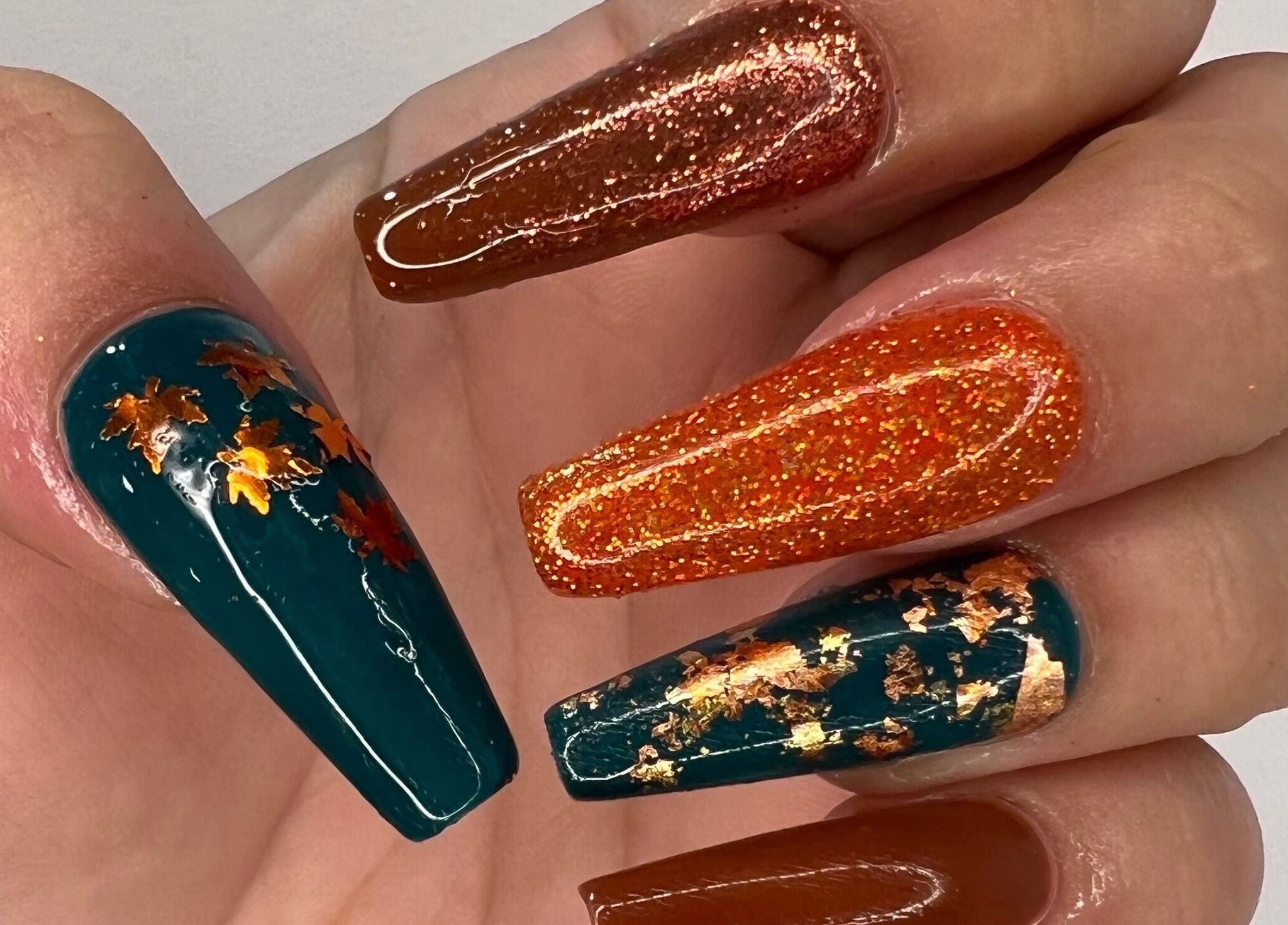 Luxurious Nails showcase stunning autumn-themed nail art with glitter in Ipswich, England, GB.