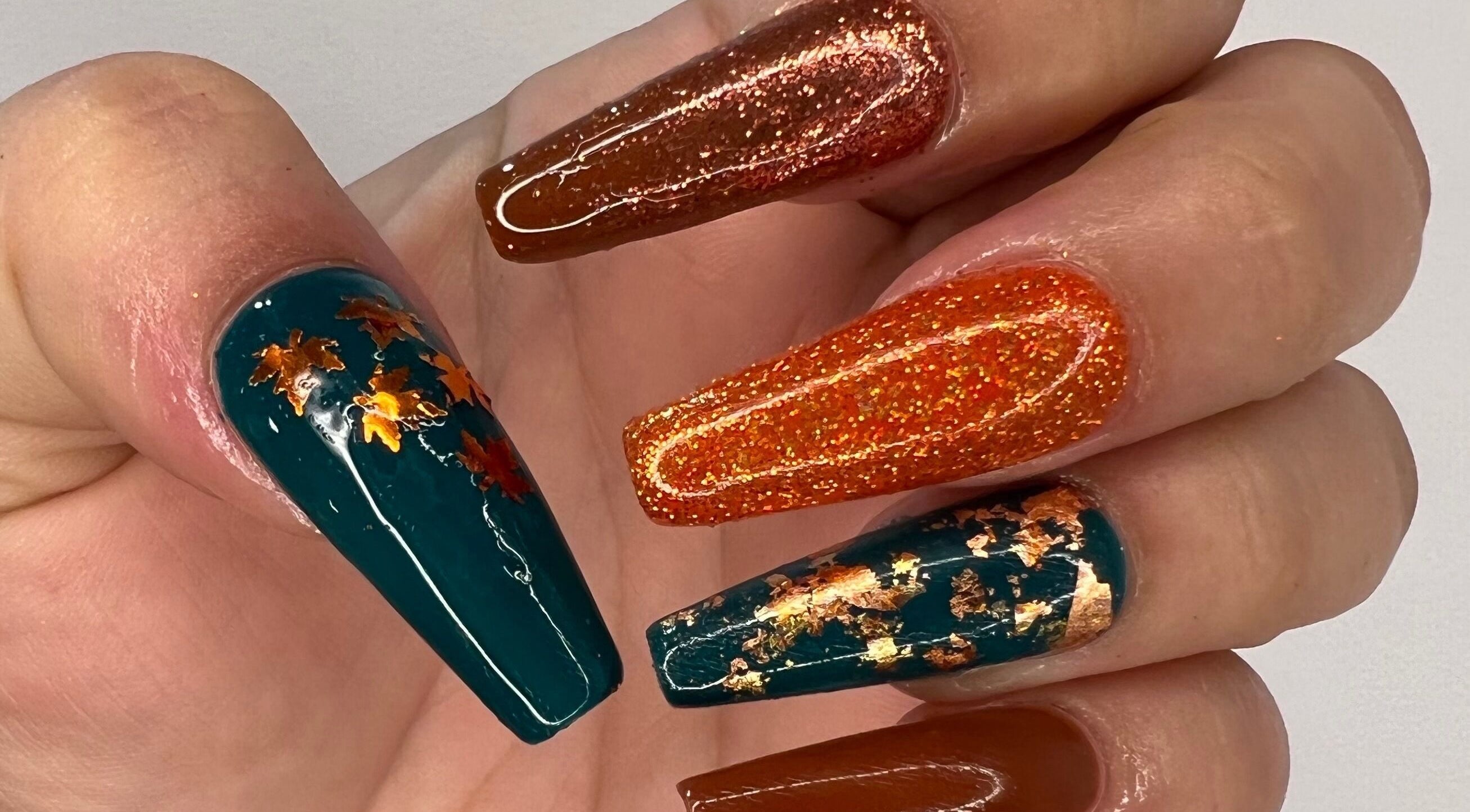 Luxurious Nails showcase stunning autumn-themed nail art with glitter in Ipswich, England, GB.