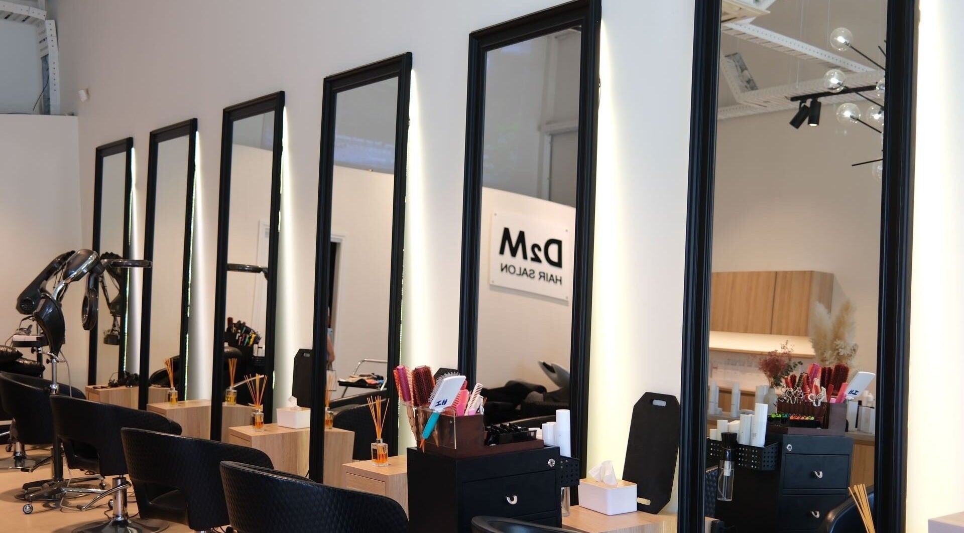 Sleek styling stations at D2M Hair Salon Malvern, Melbourne, Victoria, AU with modern decor and tools.