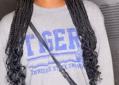 Stylish braided hairstyle at Doll House Luxury, Fairburn, Georgia, US, showcasing intricate design and elegance.