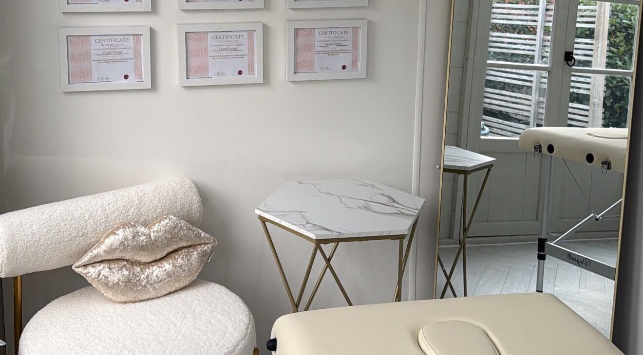 Chic interior at Aesthetics By Lish, Worcester, England, featuring a stylish chair and certificates.