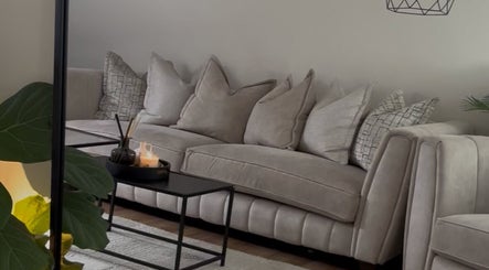 Luxurious beige sofa with plush pillows at Court by Beauty, Dartford, England, GB.