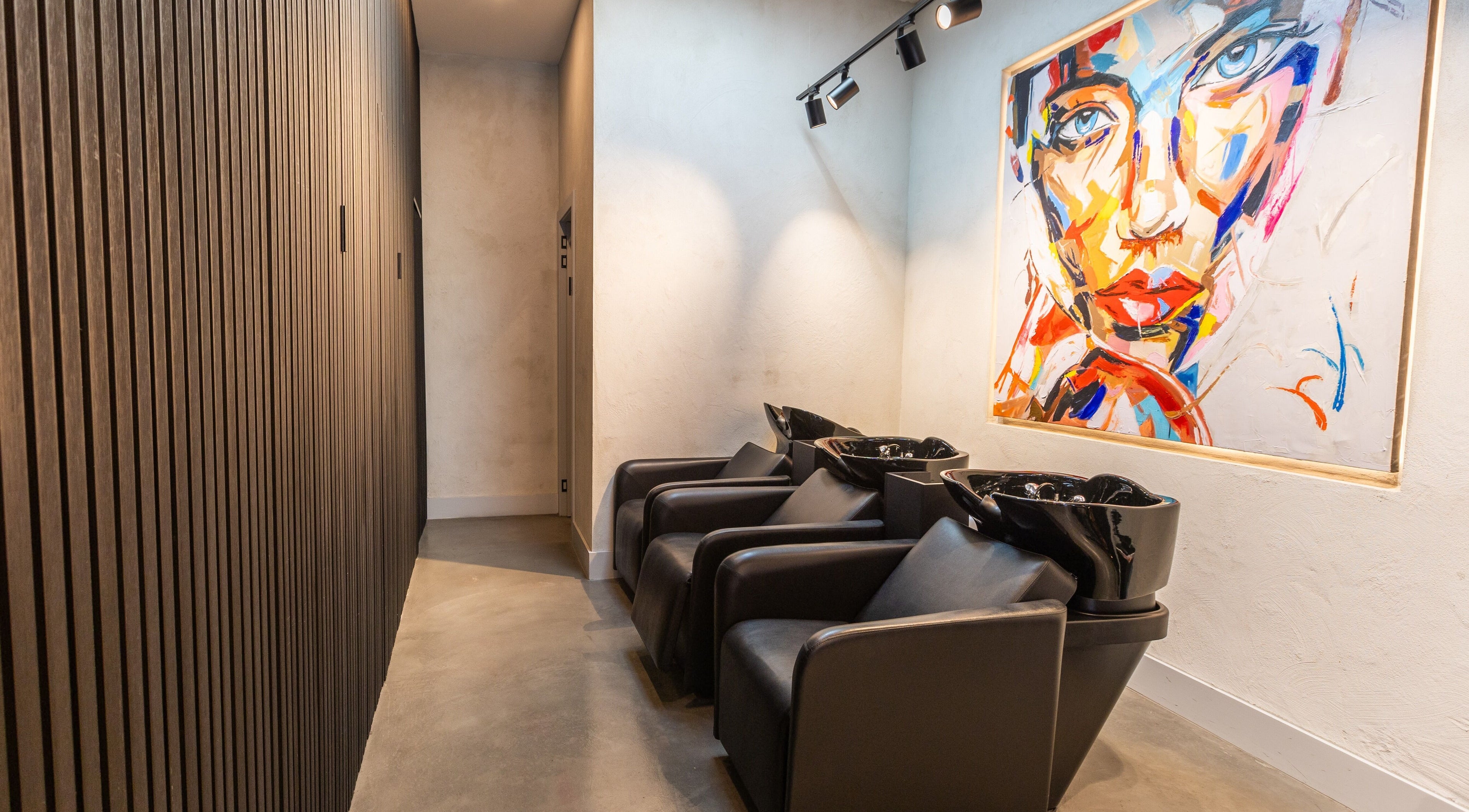 Chic salon washing station at Eran Benn, Melbourne, Victoria, AU with modern art on the wall.