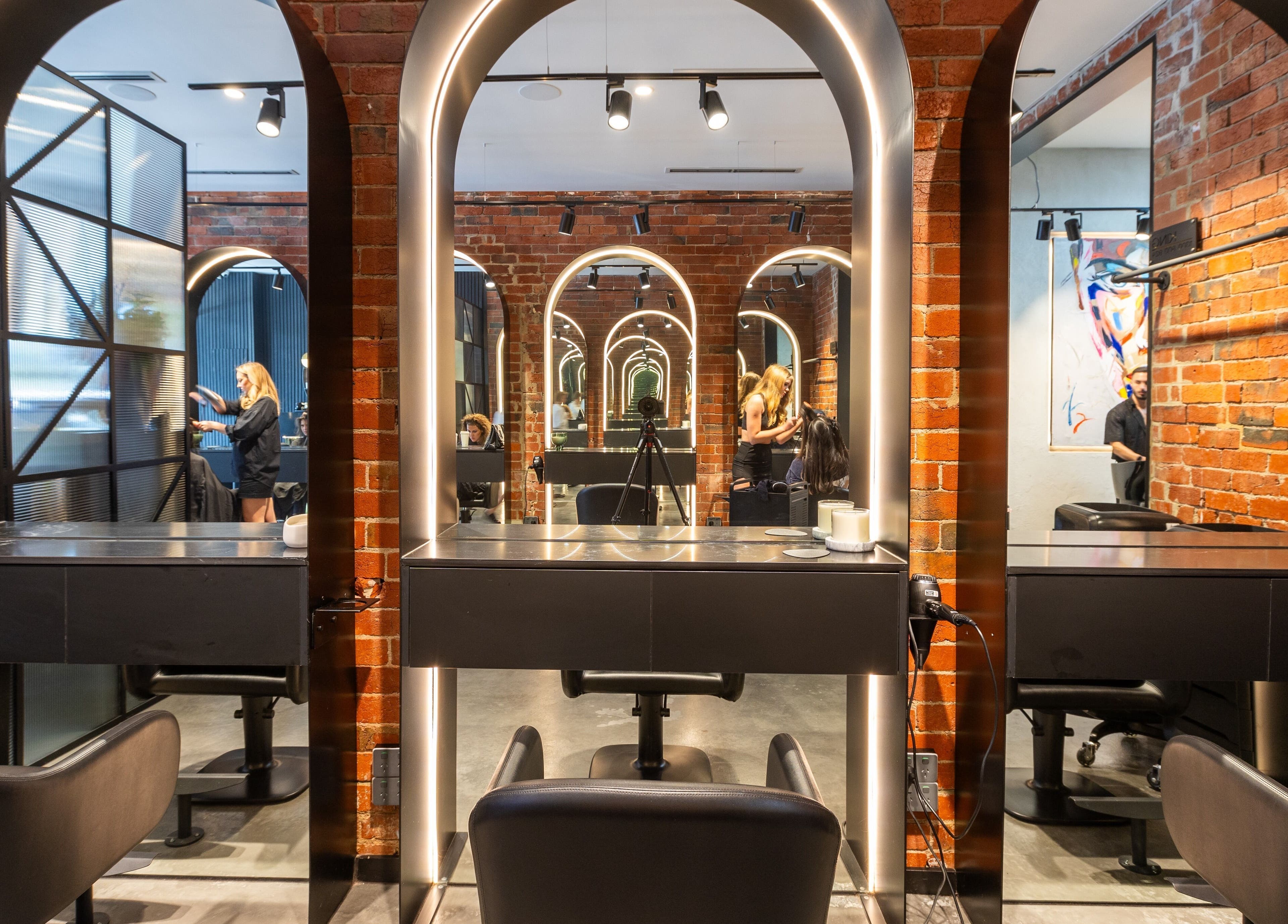 Eran Benn salon interior with modern mirrors and brick walls, Melbourne, Victoria, AU.