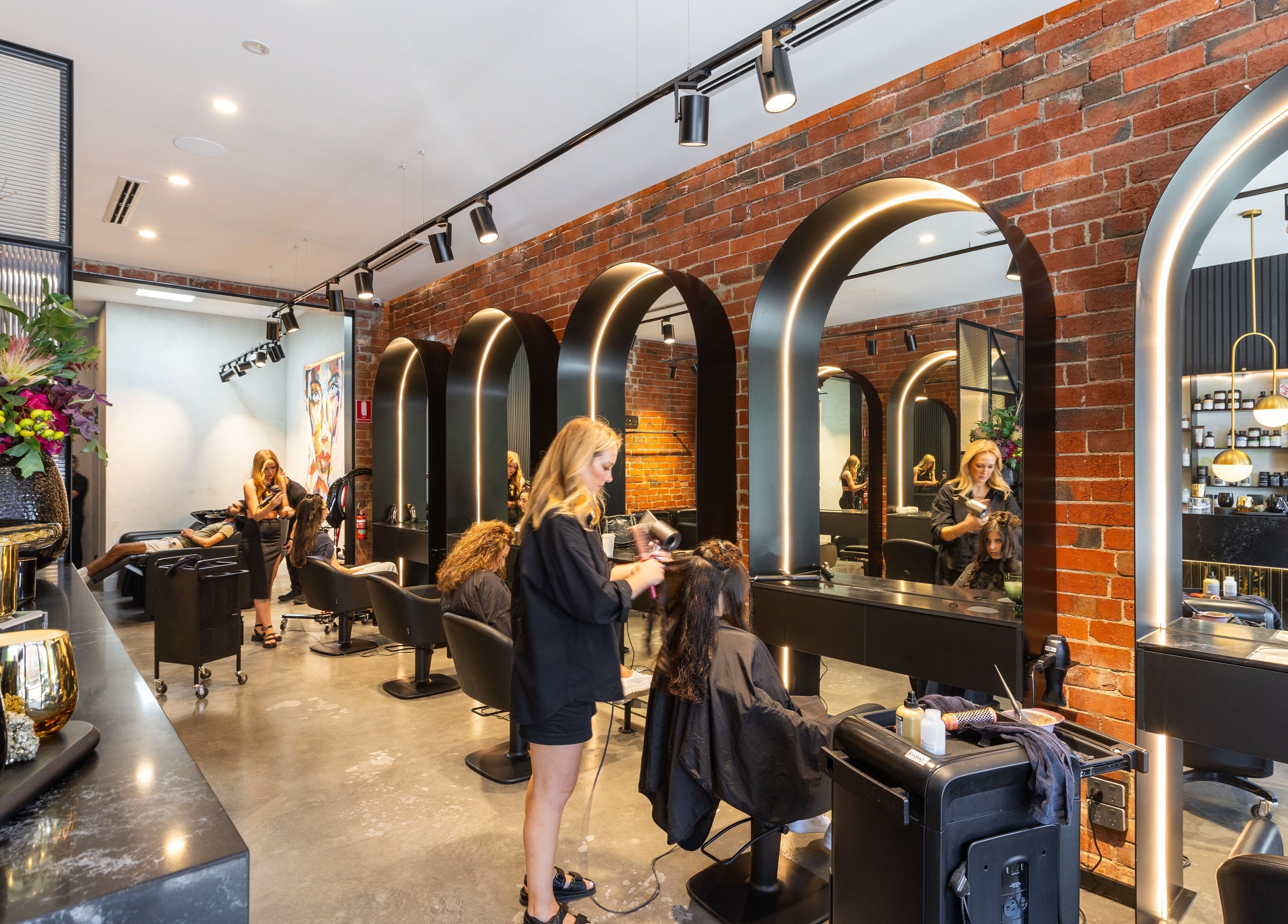Eran Benn salon in Melbourne, Victoria, AU, featuring modern styling chairs and vibrant decor.