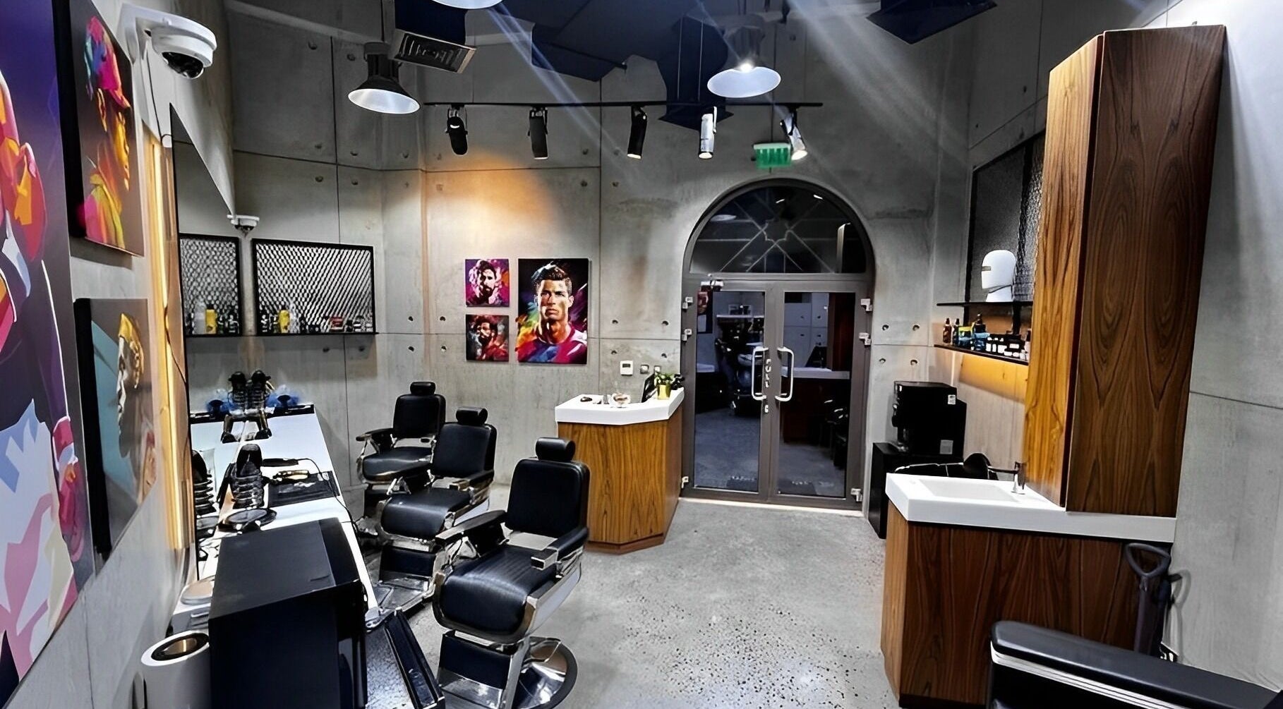 Modern interior of The Village Gents Salon in Dubai, Dubai, AE featuring sleek barber chairs and artistic decor.
