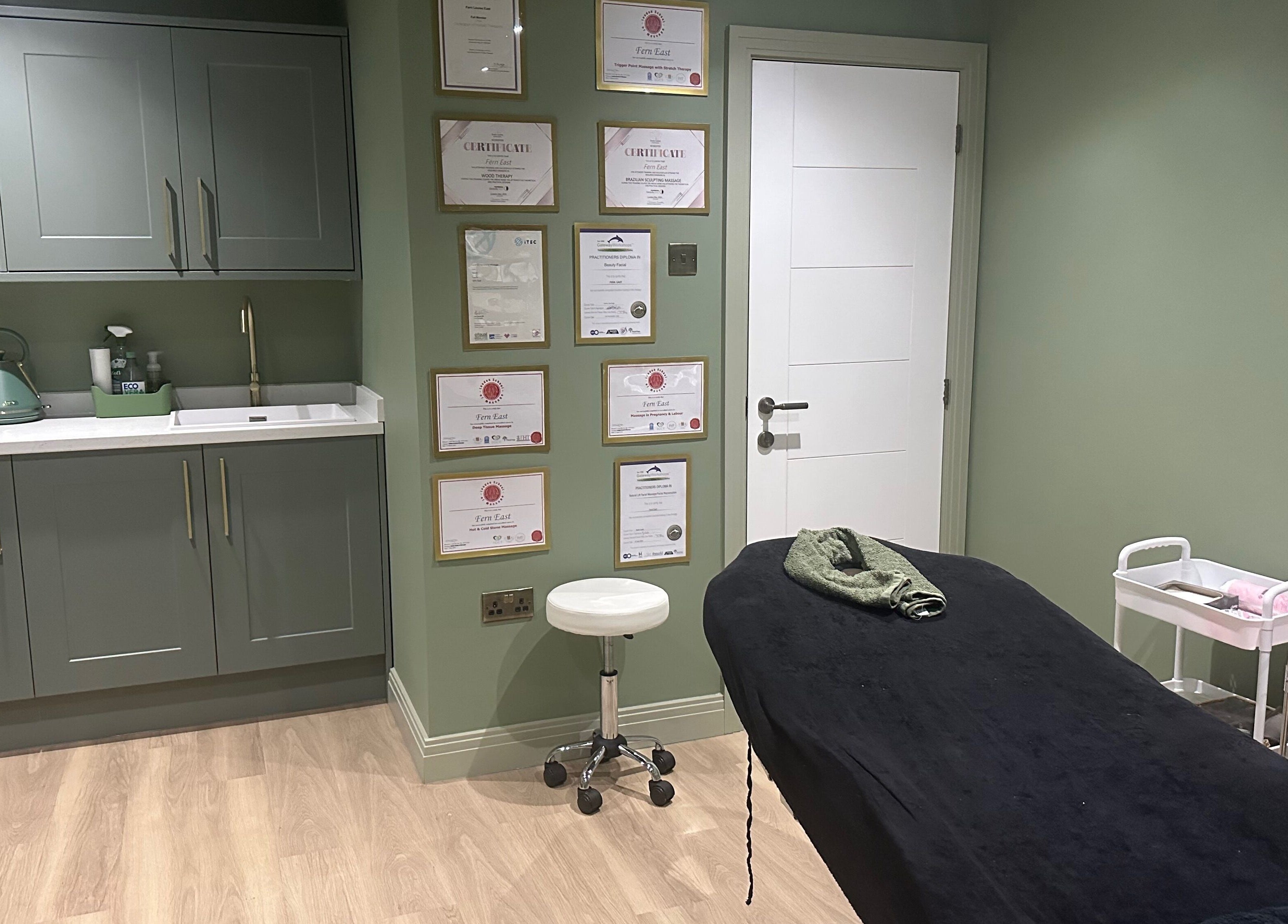 Calm treatment room at FLoE Massage Therapy in Sutton, England, GB, featuring soothing decor and therapy bed.
