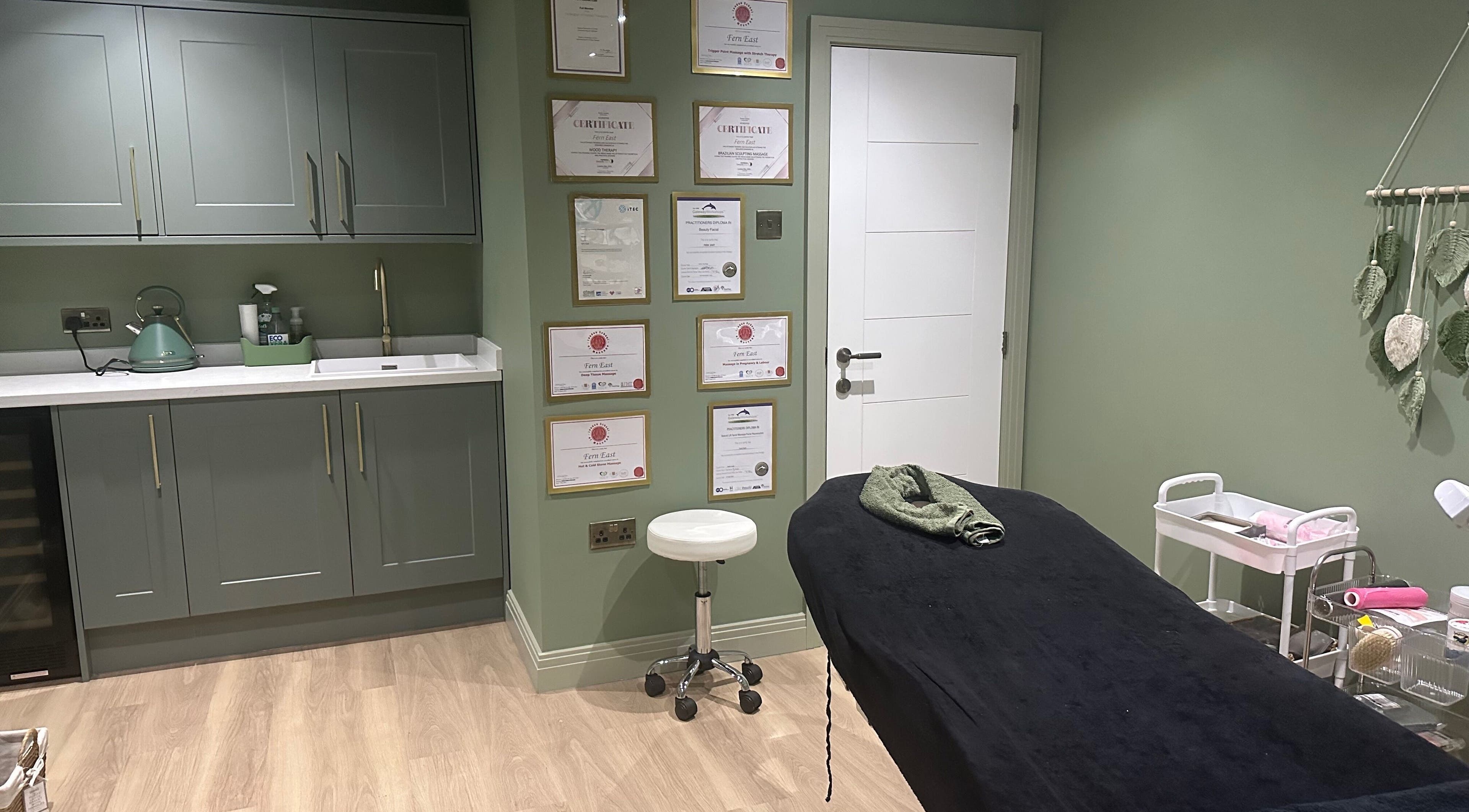 Calm treatment room at FLoE Massage Therapy in Sutton, England, GB, featuring soothing decor and therapy bed.