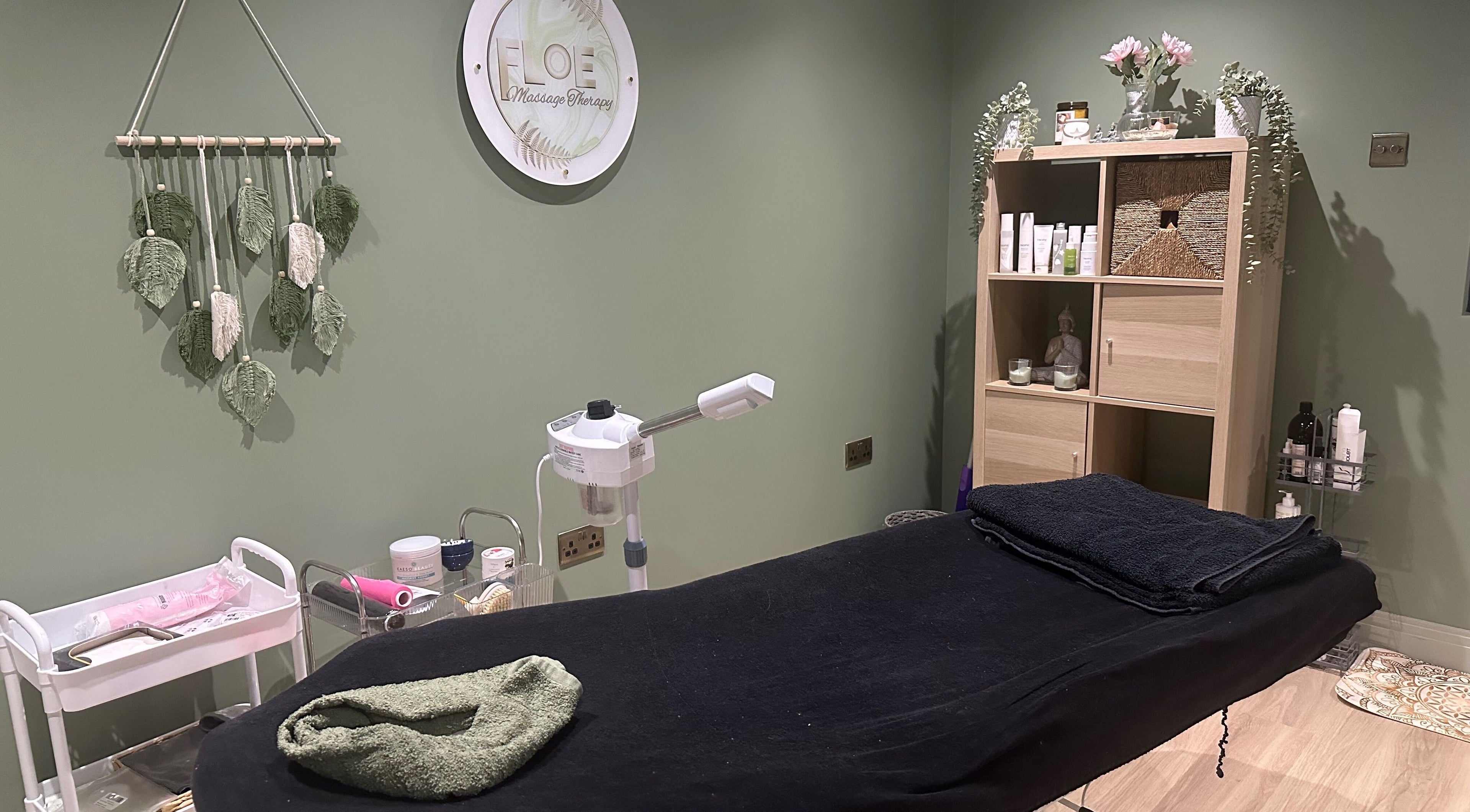 Cozy massage room at FLoE Massage Therapy in Sutton, England, GB with decor and equipment for relaxation.