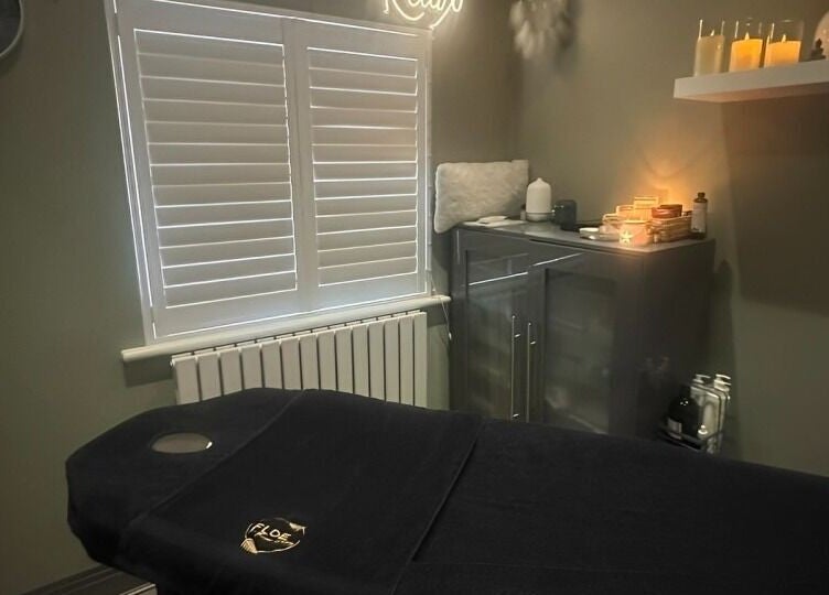 Calming massage room at FLoE Massage Therapy, Sutton, England, GB with candles and cozy decor.