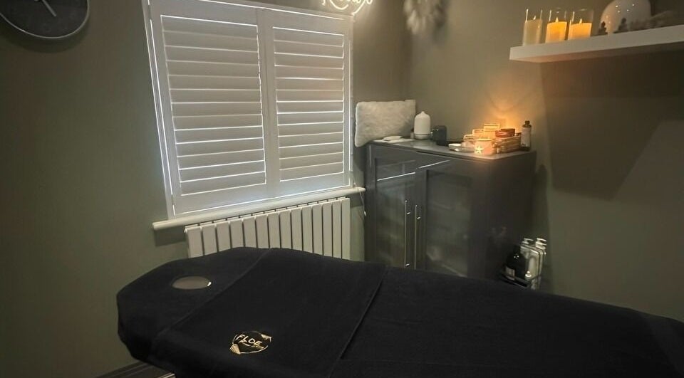 Calming massage room at FLoE Massage Therapy, Sutton, England, GB with candles and cozy decor.