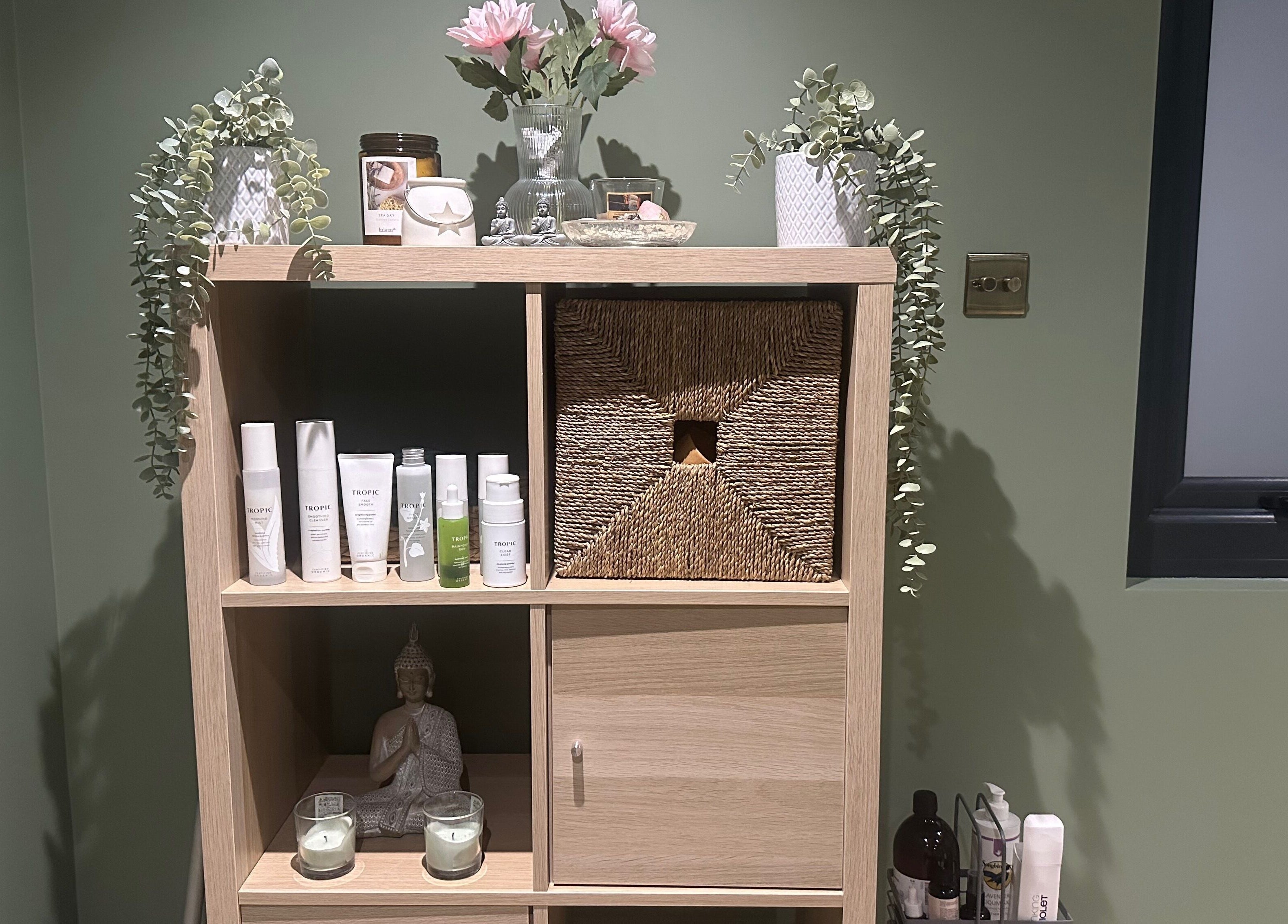 FLoE Massage Therapy's calming shelf with products and decor in Sutton, England, GB.
