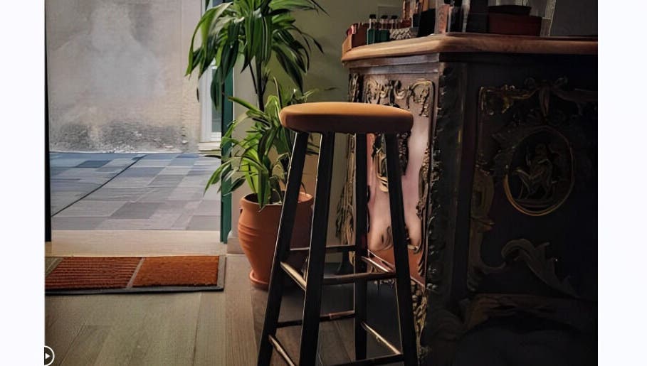 Elegant barstool and plant at The Old Barber House, Paphos, Paphos, CY, showcasing vintage decor charm.