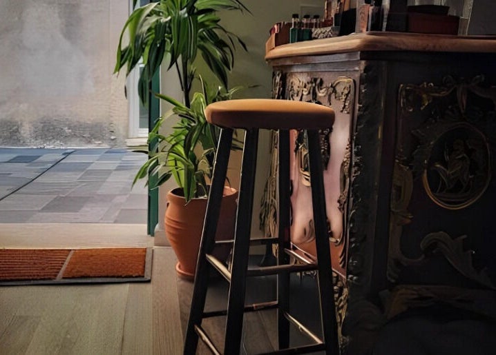Elegant barstool and plant at The Old Barber House, Paphos, Paphos, CY, showcasing vintage decor charm.