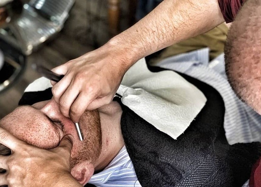 Gentleman receiving a precise shave at The Old Barber House, Paphos, Paphos, CY.