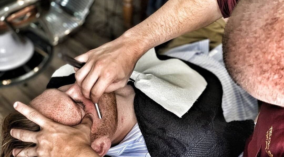 Gentleman receiving a precise shave at The Old Barber House, Paphos, Paphos, CY.