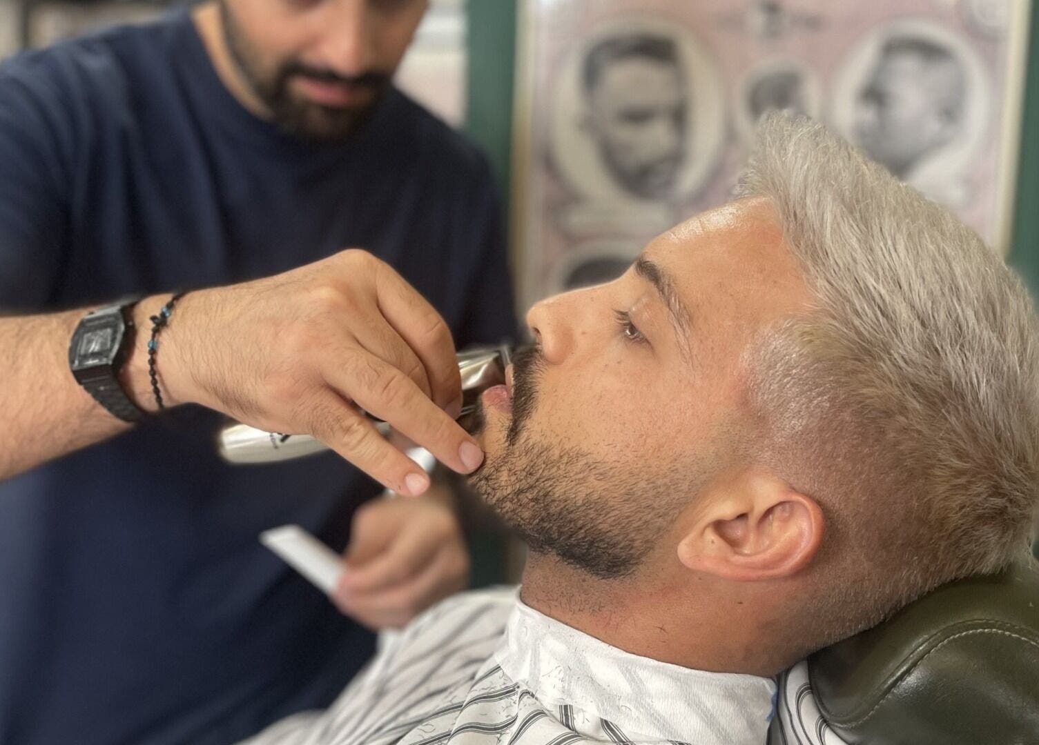 A barber trims a client's mustache at The Old Barber House, Paphos, Paphos, CY.