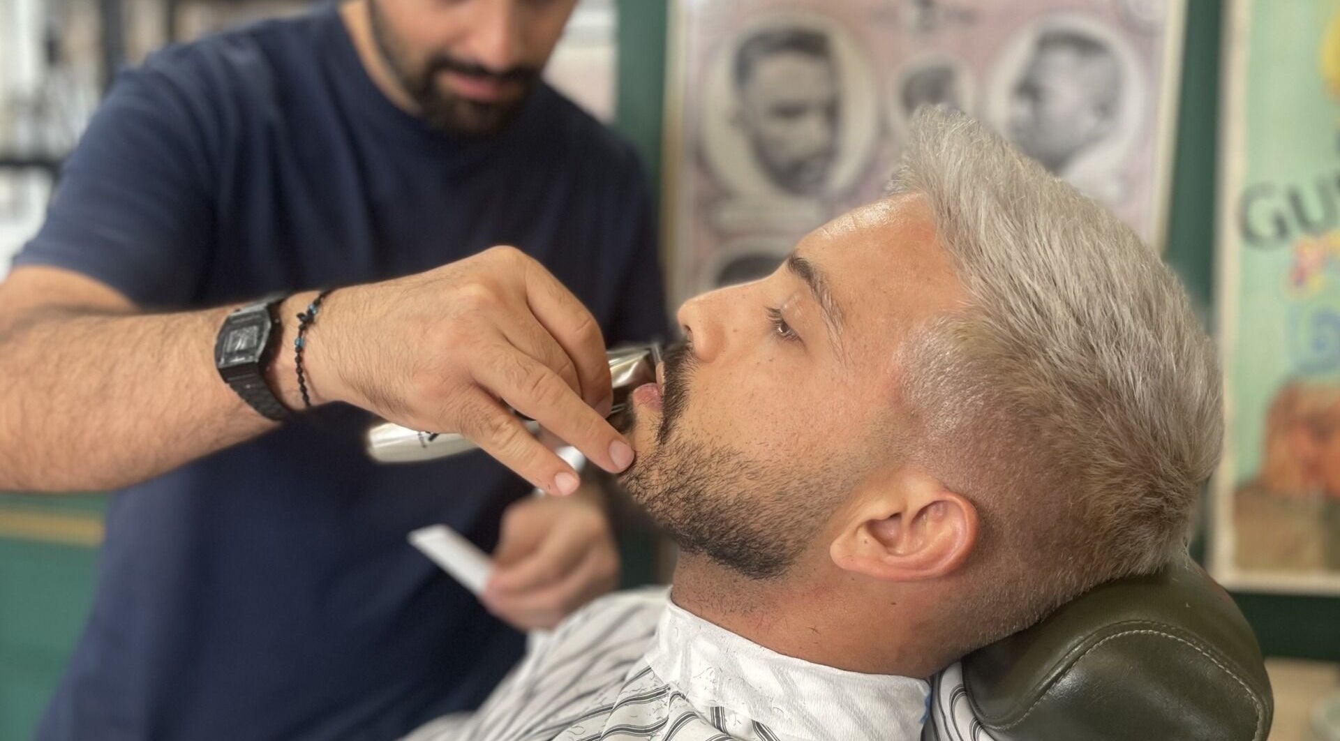 A barber trims a client's mustache at The Old Barber House, Paphos, Paphos, CY.