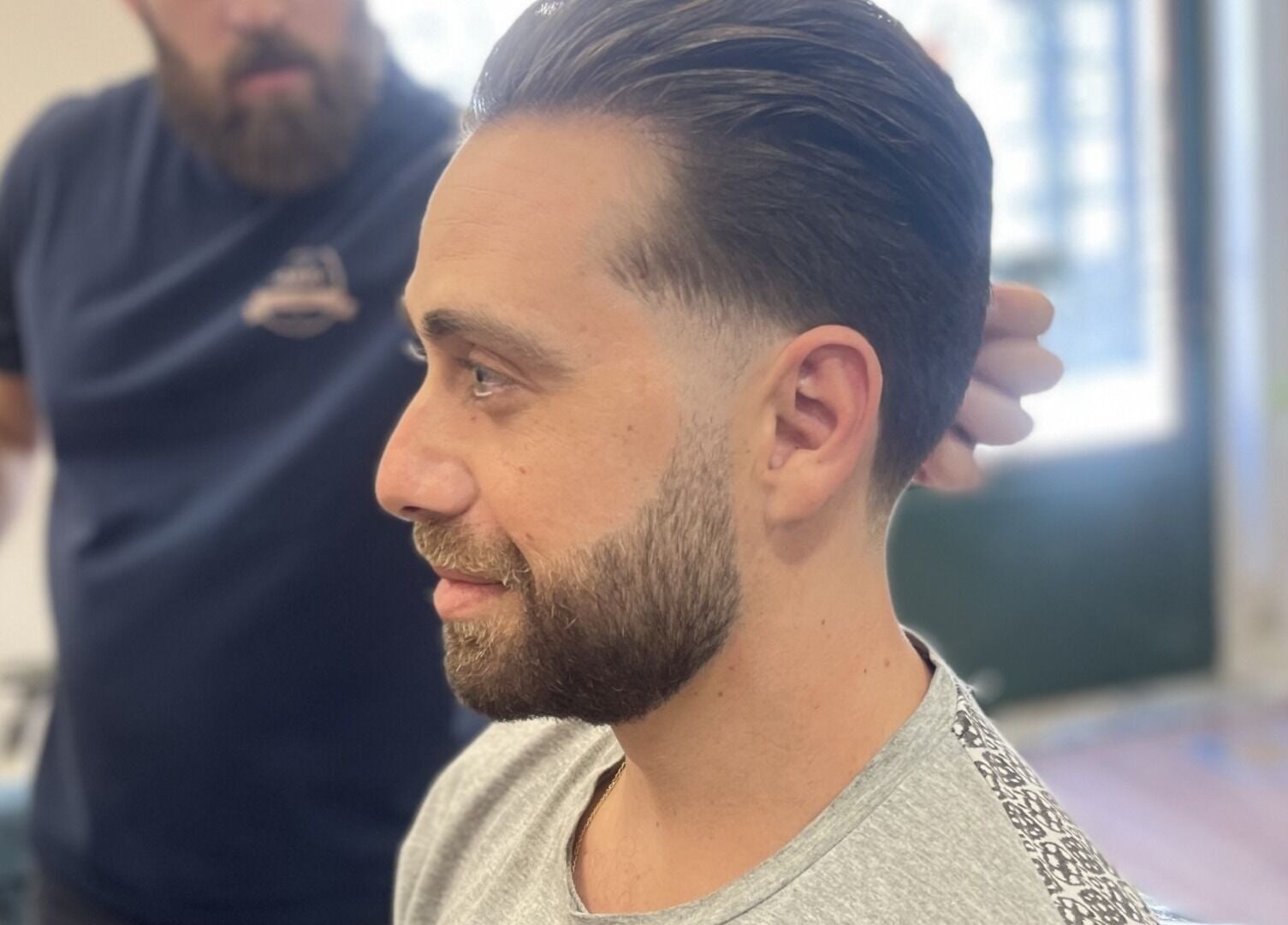 Man receives stylish haircut at The Old Barber House in Paphos, Paphos, CY. Modern barbering techniques displayed.