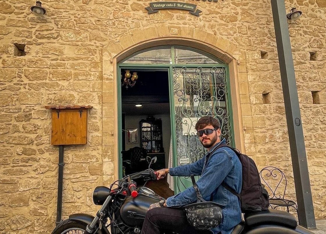The Old Barber House's rustic entrance in Paphos, Paphos, CY, featuring stone walls and vintage decor.