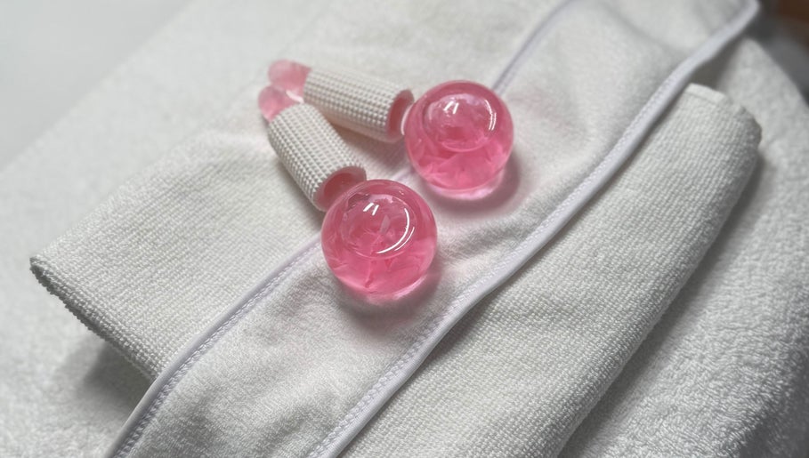 Pink therapy balls and tools on a towel at NeuGlo Skin, Burton on Trent, England, GB.