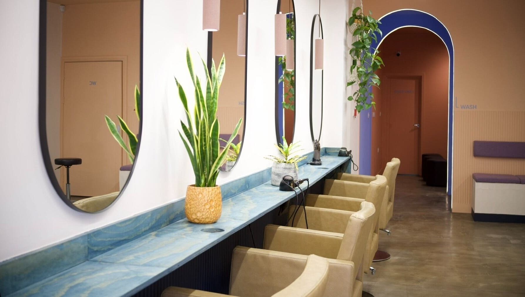 Modern salon interior at Hair by Joshuaa Shaun, Birmingham, England, GB with elegant mirrors and plants.