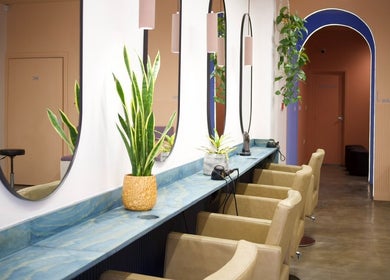 Modern salon interior at Hair by Joshuaa Shaun, Birmingham, England, GB with elegant mirrors and plants.