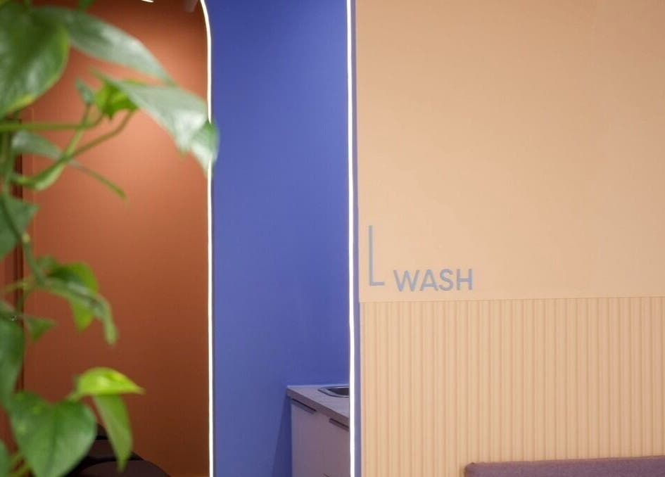 Vibrant wash area inside Hair by Joshuaa Shaun, Birmingham, England, GB, with green plant decor.