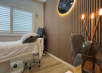 Calm treatment room at Zen Body Sculpting in Melbourne, Victoria, AU with candles and cozy bed.