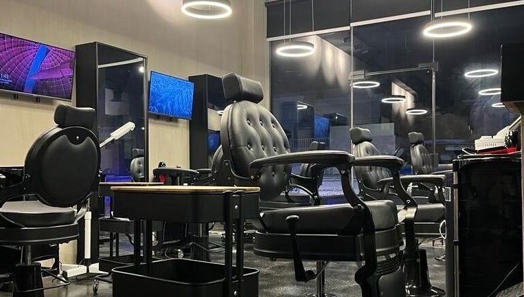Modern salon interior at Obai Salon I صالون أبي, Jeddah, Makkah Province, SA with stylish black chairs.