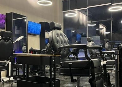 Modern salon interior at Obai Salon I صالون أبي, Jeddah, Makkah Province, SA with stylish black chairs.