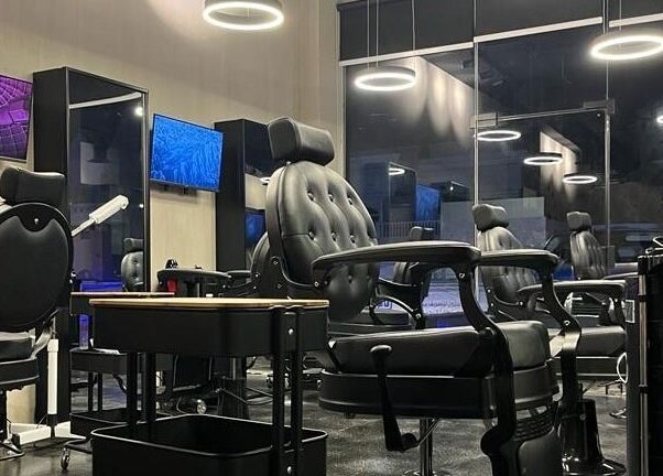 Modern salon interior at Obai Salon I صالون أبي, Jeddah, Makkah Province, SA with stylish black chairs.