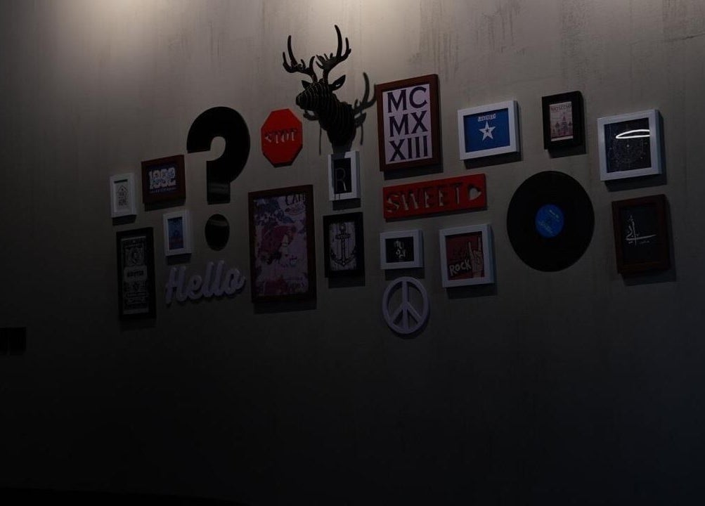 Artistic wall decor featuring frames and symbols at Obai Salon I صالون أبي, Jeddah, Makkah Province, SA.